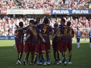 Barcelona's players celebrate their 24th La Liga title at the end of the Spanish league football match Granada CF vs FC Barcelona at Nuevo Los Carmenes stadium in Granada on May 14, 2016. Barcelona sealed their 24th La Liga title as Luis Suarez took his tally for the season to 59 goals with a hat-trick in a 3-0 win at Granada to hold off Real Madrid's late-season surge.
JORGE GUERRERO / AFP