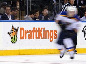 The New York Rangers and St. Louis Blues skate in front of a dasher board advertising the betting website DraftKings at Madison Square Garden on November 12, 2015 in New York City. Bruce Bennett/Getty Images/AFP
BRUCE BENNETT / GETTY IMAGES NORTH AMERICA / AFP