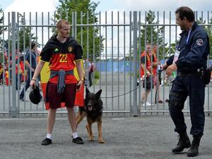 A security guard and his dog inspect a fan ahead of the Euro 2016 group E football match between Belgium and Ireland at the Matmut Atlantique stadium in Bordeaux on June 18, 2016.
NICOLAS TUCAT / AFP