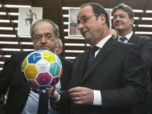 French President Francois Hollande (R) holds a soccer ball next to head of French Football Federation (FFF) Noel Le Graet (L) during his visit to the INSEP or French National Institute of Sport and Physical Education, as part of the government initiative "11 Tricolore, La France au rendez-vous" aimed at promoting top public policies, for the UEFA EURO 2016, in Paris on March 29, 2016.
Michel Euler / POOL / AFP