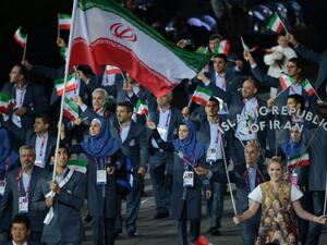 Iran's flagbearer Ali Mazaheri leads his delegation during the opening ceremony of the London 2012 Olympic Games in the Olympic Stadium in London on July 27, 2012. AFP PHOTO / CHRISTOPHE SIMON
CHRISTOPHE SIMON / AFP