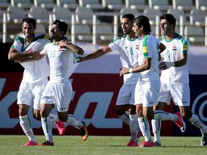Iraqi players celebrate scoring a goal against Japan's team during their 2018 World Cup qualifying football match between Japan and Iraq at the Dastgherdi Stadium in the Iranian capital Tehran on June 13, 2017.
ATTA KENARE / AFP
