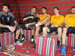 (from L to R) Juventus' Italian goalkeeper Gianluigi Buffon, Italian goalkeeper Emil Audero, German midfielder Sami Khedira, Swiss defender Stephan Lichtsteiner, and Italian defender Andrea Barzagli gather after a training session in Doha on December 21, 2016, two days before the Italian Super Cup final football match between Juventus and AC Milan in the Qatari capital.
KARIM JAAFAR / AFP