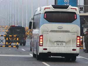A bus carrying a delegation of South Korean officials passes a military check point on the road leading to the border truce village of Panmunjom in Paju on January 15, 2018. North and South Korea began talks on January 15 on appearances by Pyongyang's state-run artistic performers at next month's Winter Olympics in the South, after the North agreed to attend the Games.

YONHAP / AFP
