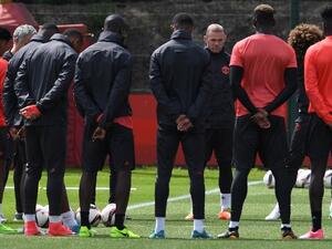 Manchester United's English striker Wayne Rooney (4R) stands with teammates as they observe a minute's silence for the victims of yesterday's terror attack at the Ariana Grande concert at the Manchester Arena, during a team training session at the club's training complex near Carrington, west of Manchester in north west England on May 23, 2017, ahead of their UEFA Europa League final football match against Ajax.
Paul ELLIS / AFP