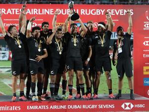 New Zealand's players celebrate with the trophy of the Men's Sevens World Rugby Dubai Series Cup after the Final match between USA an New Zealand on December 01, 2018.
KARIM SAHIB / AFP