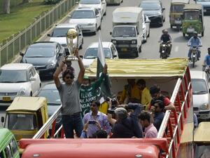 Pakistani cricketer Mohammad Irfan holds the 2019 ICC Cricket World Cup trophy atop a bus during a parade event in Lahore on October 3, 2018. The 2019 Cricket World Cup is the scheduled to be hosted by England and Wales from May 30th to July 14th of 2019.
ARIF ALI / AFP