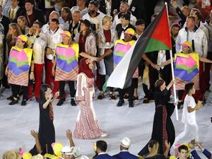 Palestine's Mayada Sayyad carries their country's flag as they lead teammates into the stadium during the opening ceremony of the Rio 2016 Olympic Games at the Maracana stadium in Rio de Janeiro on August 5, 2016.
Thomas COEX / AFP