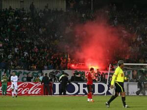 Egyptian fans of Al-Masry light flares during a football match against Al-Ahly in Port Said on February 1, 2012. At least 74 people were killed and hundreds injured when rival fans clashed after the football match, highlighting a security vacuum in post-revolution Egypt. AFP PHOTO/STR
STR / AFP