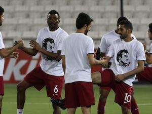 Qatar's national team players wear t-shirts bearing portraits of Emir Sheikh Tamim bin Hamad Al-Thani, in support the Qatari leader in the ongoing diplomatic crisis surrounding Qatar and other Gulf countries as they warm up prior to their World Cup 2018 Asia qualifying football match between Qatar and South Korea at the Jassim Bin Hamad stadium in Doha on June 13, 2017.
KARIM JAAFAR / AFP