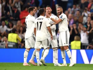 لاعبو ريال مدريد يحتفلون بهدف بنزيمة (يمين)