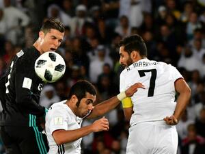 Real Madrid's Portuguese forward Cristiano Ronaldo (L) vies for the header with al-Jazira's Emirati defender Musallem Fayez (C) and Emirati forward Ali Mabkhout (R) during the FIFA Club World Cup semi-final match in the Emirati capital Abu Dhabi on December 13, 2017.
GIUSEPPE CACACE / AFP