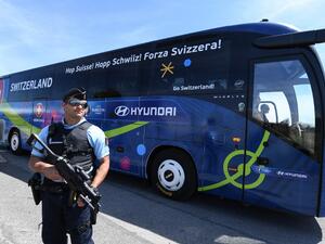 A policeman stands guard as Switzerland's national football team leaves Montpellier's airport by bus, on June 6, 2016, four days ahead of the start of the Euro 2016 European football championships.
PASCAL GUYOT / AFP
