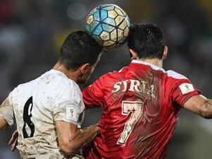 Omar Khrbin of Syria (R) and Morteza Pouraliganji of Iran head the ball during the 2018 World Cup qualifying football match between Syria and Iran at Tuanku Abdul Rahman Stadium in Seremban on November 15, 2016.
MOHD RASFAN / AFP