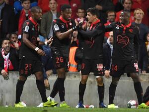 Nice's Algerian defender Youcef Atal (C) is congratulated by his teammates after scoring a goal during the French L1 football match between Nîmes and Nice, on November 10, 2018 at the Costières stadium in Nîmes, southern France.
PASCAL GUYOT / AFP