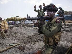 Soldiers of the Sudan People Liberation Army (SPLA) celebrate while standing in trenches in Lelo, outside Malakal, northern South Sudan, on October 16, 2016. (AFP/Albert Gonzalez Farran)