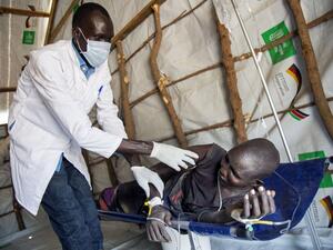 A medical officer of the International Rescue Committee examines a woman suffering from cholera on March 4, 2017, in a clinic in Ganyiel, Panyijiar county, in South Sudan. (AFP/Albert Gonzalez Farran)