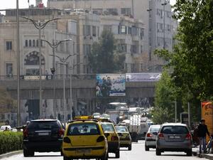Syrian civilians go about daily life in Damascus on the first day of the ceasefire, February 27. (AFP/Louai Beshara)