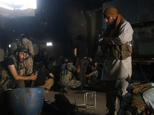 Fighters from the opposition forces pray and rest in a building as they battle in the Ramouse industrial neighbourhood on the southern outskirts of Aleppo in a bid to break the government siege on the northern Syrian city. (AFP/File)
