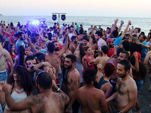 Syrians dance during a party at the Wadi Qandeel beach (Jellyfish Valley) in the coastal city of Latakia. (AFP/File)