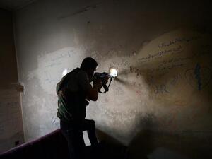 A Syrian rebel fires toward a government held area in Aleppo (AFP Photo/ Dimitar Dilkoff)