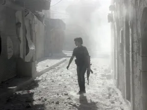 A soldier stands among debris inside Syria (AFP/FILE)