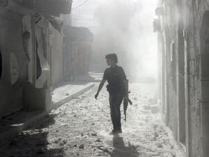 A soldier stands among debris inside Syria (AFP/FILE)