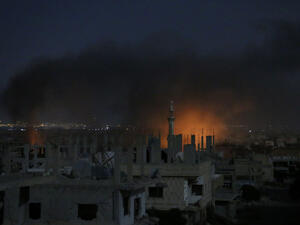 Smoke and flames rise from buildings following a reported government strike on a rebel-held area in Syria's southern city of Daraa late on July 3, 2017. (AFP)