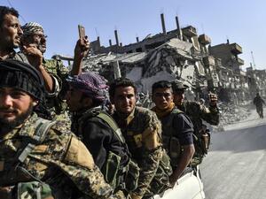 Kurdish fighters of the Syrian Democratic Forces (SDF) ride in the back of a truck in Raqa. (AFP/ File Photo)
