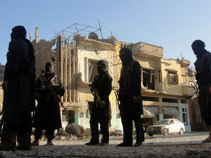 A picture released by opposition-run Shaam News Network on July 2, 2013 shows rebel fighters scouting the area in Syria's central city of Homs. (Source:  "AFP PHOTO / HO / SHAAM NEWS NETWORK")
