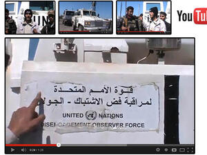  An image grab taken from a video uploaded on YouTube on Wednesday, allegedly shows armed fighters standing in front of a United Nations Disengagement Force (UNDOF) vehicle in the Golan Heights between Syria and Israel. (Image courtesy of AFP / YouTube)