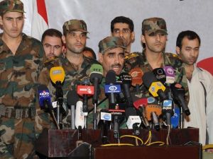 مقدم سوري مع مجموعة من العسكريين خلال مؤتمر صحافي في دمشق