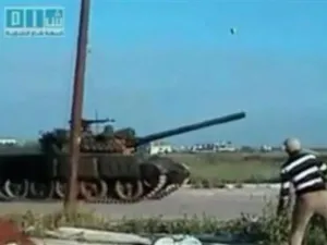 متظاهر سوري يقذف دبابة للجيش بالحجارة