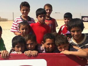 Syran refugee children at Zaatari camp awaiting their turn to play football at a workshop organized by Brazilian  coaches (Al Bawaba) 