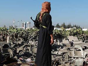 A Yemeni man observes the damage following a Saudi-led coalition airstrike near Sanaa's airport.  (AFP/File)