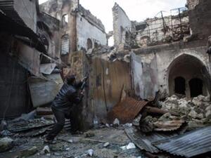 A Syrian rebel takes aim amid destruction (AFP)
