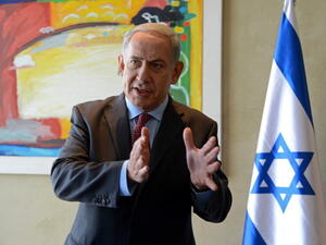 Israeli Prime Minister Benjamin Netanyahu speaks to the press following his meeting with US Secretary of State at Ben Gurion airport near Tel Aviv on November 8, 2013. [Getty Images]