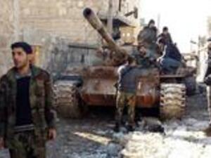 Government forces chat near a tank near the Shia villages of Nabbul and Zahra in Syria's northern Aleppo province which have been under siege by Daesh for three years on February 2, 2016. (AFP/George Ourfalian)