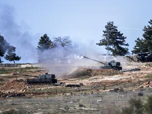 Turkish tanks stationed at a Turkish army position near the Oncupinar crossing close to the town of Kilis, south central Turkey, fire towards the Syria border, on February 16, 2016. (AFP/Bulent Kilic)
