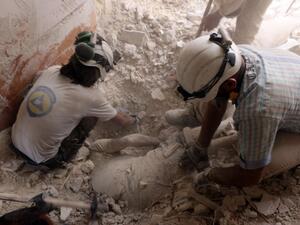 Syrian civil defence volunteers pull a body from under the rubble following a reported attack by Syrian government forces on May 27, 2016, in the Tariq al-Bab neighbourhood in the northern city of Aleppo. (AFP/Thaer Mohammed)