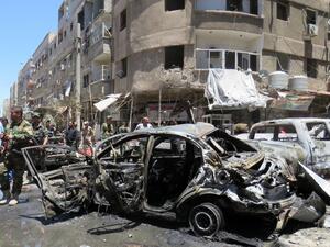 Syrians gather at the scene of a double bombing attack on June 11, 2016 outside the Sayyida Zeinab shrine, which is revered by Shiites around the world, some ten kilometres south of the centre of Damascus, in the latest in repeated deadly strikes on the revered site, state media said. (AFP/Stringer
