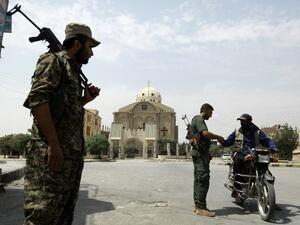 Members of the Kurdish police patrol in the neighborhood of Al-Masaken in the northeastern Syrian city of Hasaka during ongoing fighting with regime forces on August 22, 2016. (AFP/Delil Souleiman)