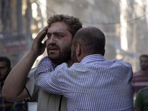 Syrians react as the bodies of children are pulled from the rubble of a budling following government forces air strikes in the rebel held neighbourhood of Al-Shaar in Aleppo on September 27, 2016. (AFP/Karam al-Masri)