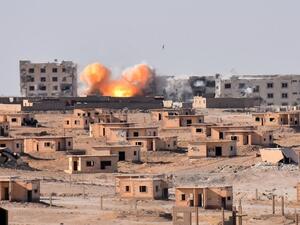 Smoke rises from buildings in the area of Bughayliyah, on the northern outskirts of Deir Ezzor on September 13, 2017, as Syrian forces advance during their ongoing battle against ISIS. (George Ourfalian/AFP)