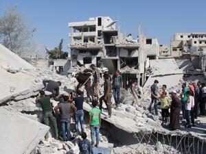 Syrian residents and members of the Syrian Civil Defence, also known as White Helmets, search for victims amid the rubble of a building following a reported overnight air strike in the rebel-held town of Armanaz, in Idlib province near the Turkish border, on September 30, 2017 (Omar Haj Kadour/AFP)