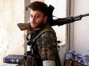 A Syrian Democratic Forces fighter in the suburb of al-Rumaniya on the western outskirts of Raqqa on June 27, 2017 after the area was seized from Daesh. (Delil Souleiman/AFP)