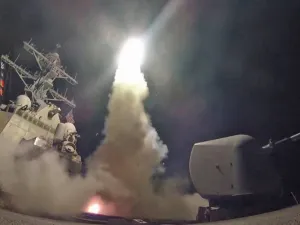 The guided-missile destroyer USS Porter conducts a strike against a Syrian airfield from the Mediterranean Sea on Friday. | AFP