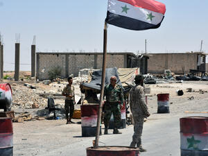 Members of the Syrian pro-government forces holding a security checkpoint in the village of Khirbat al-Sa'ab, on the western outskirts of Raqa province. (AFP)