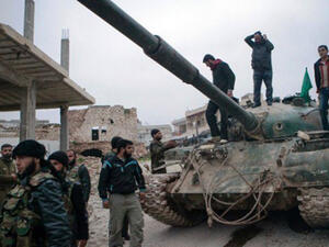 A file photo of Syrian rebels gather around a T-72 tank, captured from government forces. (AFP)