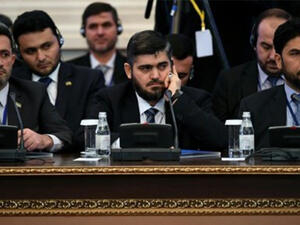 Chief Syrian rebel negotiator Mohammad Alloush (C) of the Jaish al-Islam (Army of Islam) faction attends the first session of peace talks at Astana's Rixos President Hotel on January 23, 2017. (AFP)